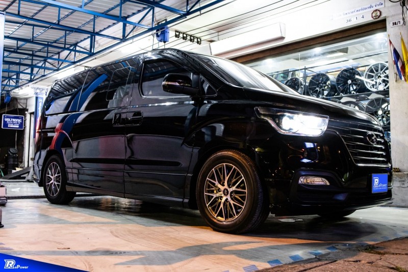 A sleek and modern black van parked in a garage, representing a high-quality limousine service.