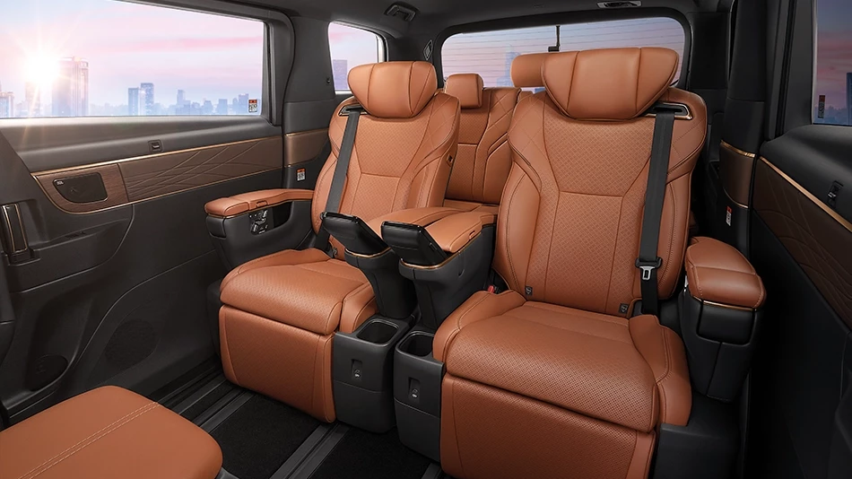Interior of a luxurious limousine, Alphard 2.5 HEV Luxury model, featuring light brown leather reclining seats with armrests and cup holders.