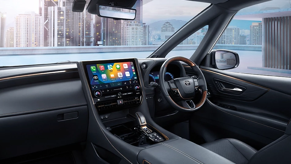 Interior of a Vellfire 2.5 HEV car, featuring luxurious and modern design, suitable for limousine services. It includes a large touchscreen displaying various applications, a leather-wrapped steering wheel, and comfortable seats.
